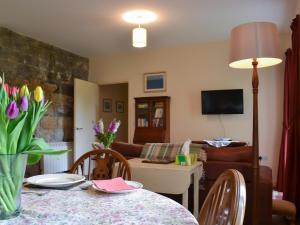 a living room with a table and a couch at Quartermasters in Brancepeth