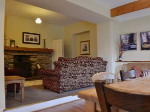 a living room with a couch and a fireplace at Helm View in Windermere