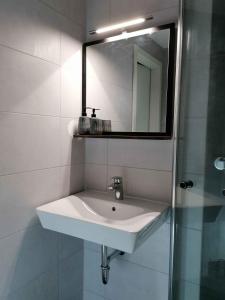 a white sink in a bathroom with a mirror at Ferienhaus Glücksmomente in Möhnesee