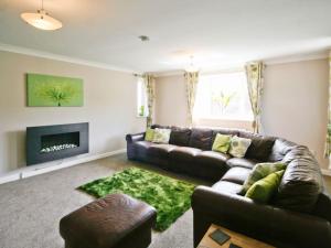 a living room with a couch and a fireplace at Beach Retreat - E5558 in Mundesley