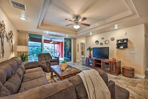 a living room with a couch and a tv at Step-Free Bullhead City Condo with Balcony! in Bullhead City