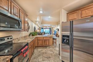 a kitchen with wooden cabinets and stainless steel appliances at Step-Free Bullhead City Condo with Balcony! in Bullhead City