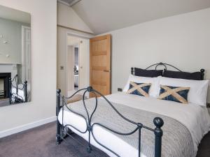 a bedroom with a bed and a fireplace at Knocktinkle in Gatehouse of Fleet