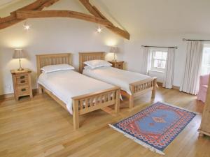 A bed or beds in a room at Wordsworth Cottage