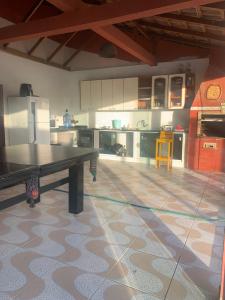 a large kitchen with a table in the middle of it at Casa c piscina matinhos S Etiene in Matinhos