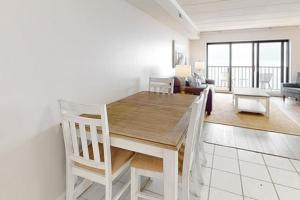 a dining room with a table and a living room at Marigot Beach 1207 in Ocean City