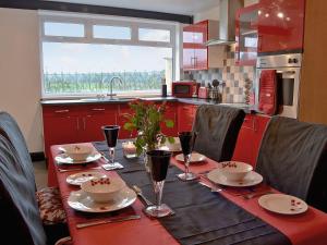 a table with plates and glasses on top of it at Bont Cottage in Kidwelly