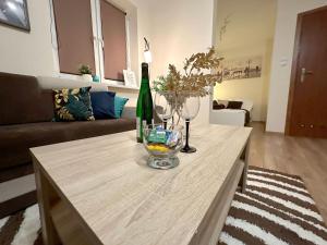 a living room with a table with a bottle of wine at Apartament w górach in Mszana Dolna