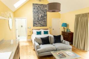 a living room with a bed and a couch at Meadow Barn in Axminster