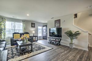 a living room with a couch and a tv at Cozy Durham Home - 9 Mi to Duke University! in Durham