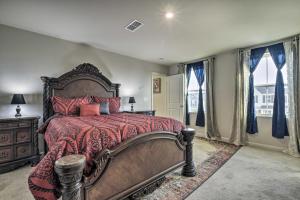 a bedroom with a large bed with a red comforter at Cozy Durham Home - 9 Mi to Duke University! in Durham