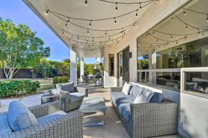an outdoor patio with wicker furniture and string lights at Spacious Scottsdale Home with Private Pool! in Phoenix