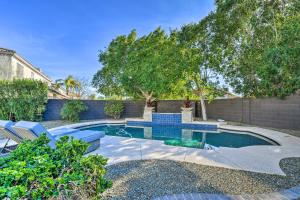 a swimming pool in a yard with chairs and trees at Spacious Scottsdale Home with Private Pool! in Phoenix