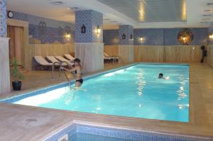 two people in a swimming pool in a hotel at Taksim Gonen Hotel in Istanbul