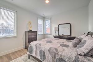 a bedroom with a bed and a dresser and a mirror at Winter Escape! Downtown Traverse City Condo in Traverse City