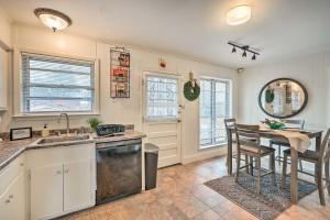 a kitchen with a sink and a table with chairs at Memphis Vacation Rental - half Mi to Graceland in Memphis