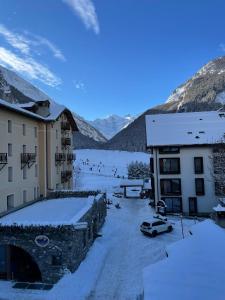 a view of a building with snow on the ground at Casa Gran Paradiso in Cogne