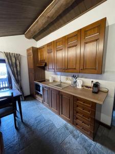 a kitchen with wooden cabinets and a counter top at Casa Gran Paradiso in Cogne