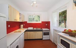 a kitchen with white counters and a red brick wall at La bayorre in Hyères