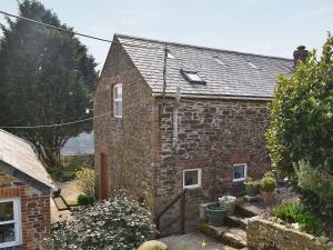 an old brick house with a garden in front of it at The Stables in Dunterton