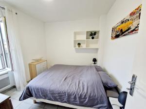 ein weißes Schlafzimmer mit einem Bett und einem Fenster in der Unterkunft Agréable appartement T2 Centre ville in Valence