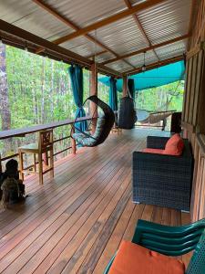 a screened porch with a hammock on a deck at Bahías Lodge in Rincón