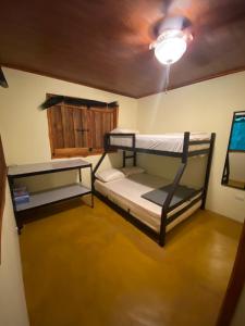 two bunk beds in a room with a ceiling at Bahías Lodge in Rincón