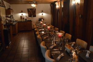 a long dining room with a long table and chairs at Hotel Le Genepy in Tignes