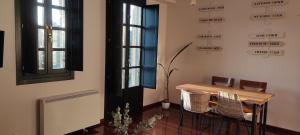 a table and chairs in a room with signs on the wall at Apartamento Parque Portovello in Allariz