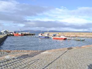 a group of boats are docked in a harbor at Tides in Cromarty