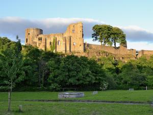 a castle sitting on top of a hill at Mill Stone Cottage in Wolsingham