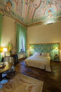 a bedroom with a bed and a coffered ceiling at Palazzo Carletti in Montepulciano