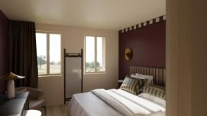 a bedroom with a large bed and two windows at Relais Manderen in Manderen