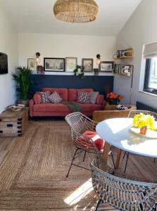 a living room with a red couch and a table at Meadows Lodge in York