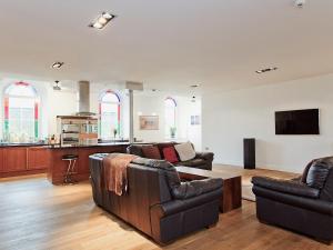 a living room with two couches and a tv at Dales Chapel in Middleton in Teesdale