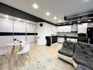 a living room with a couch and a table at Апартаменты LUX + in Pavlodar