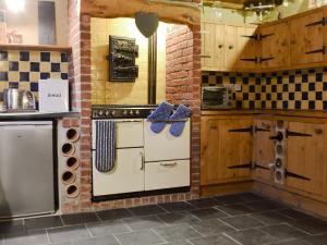 a kitchen with a refrigerator and a stove in it at The Stables in Whitland