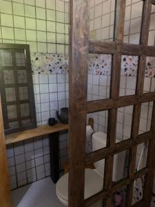 a bathroom with a toilet and a mirror at Vivenda Vivencias in Matta de São João