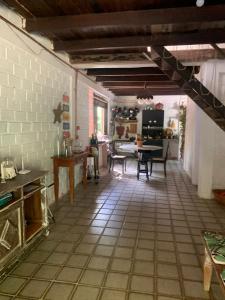 a kitchen with a tile floor and a table at Vivenda Vivencias in Matta de São João