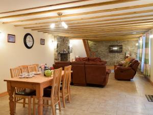 a living room with a wooden table and chairs at Penrhiw in Llangeitho