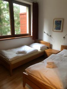 เตียงในห้องที่ Zaži Apartmány Fatrapark Hrabovo