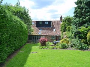 a house with a garden in front of it at Chapel Cottage in Sharrington