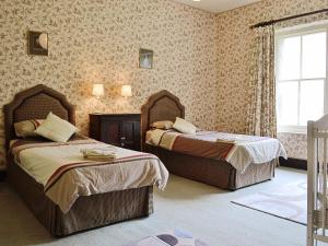 a bedroom with two beds and a window at Maes Gwyn - Hw7644 in Llandudno