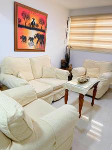 a living room with two couches and a table at Demetris apartment in Meneou
