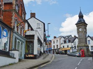 a town with a clock tower on a street at Garden Lodge in Llanvair Waterdine