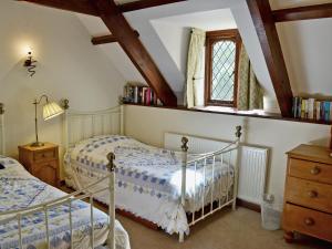 a bedroom with two beds and a window at The Manor Wing in Par