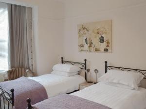 two beds sitting next to each other in a bedroom at Sandfield The Promenade in Southport