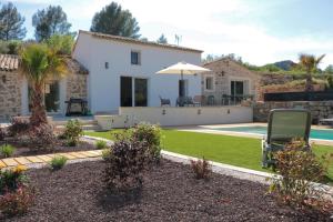 a villa with a swimming pool and a house at La maurette piscine chauffée en mai et octobre in La Motte