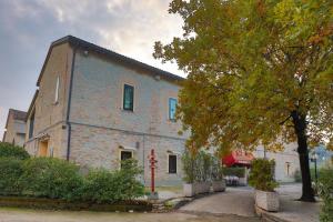 a large brick building with a tree in front of it at Villa D&D in Parma