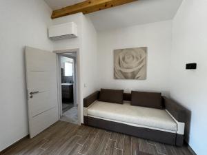 a couch in a room with a painting on the wall at La maurette piscine chauffee in La Motte